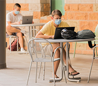 Students don face coverings while on campus on the first day of classes, Aug. 24. Though most classes began in an online format, about 5,000 students attended  essential courses such as research labs, in person. (Image: Chris Richards/University Communications)