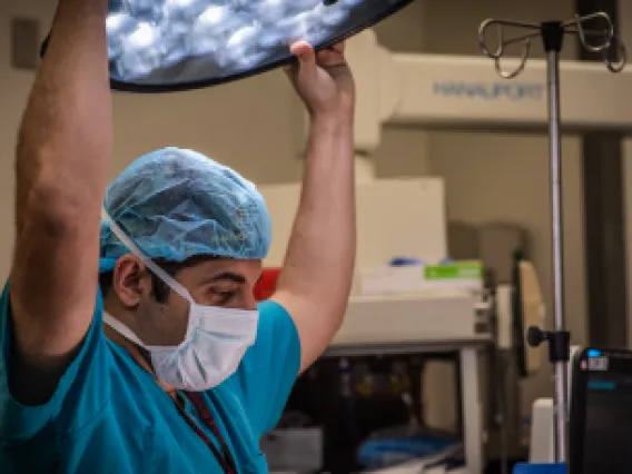 University of Arizona surgical residents and fellows stand in front of an operating table.