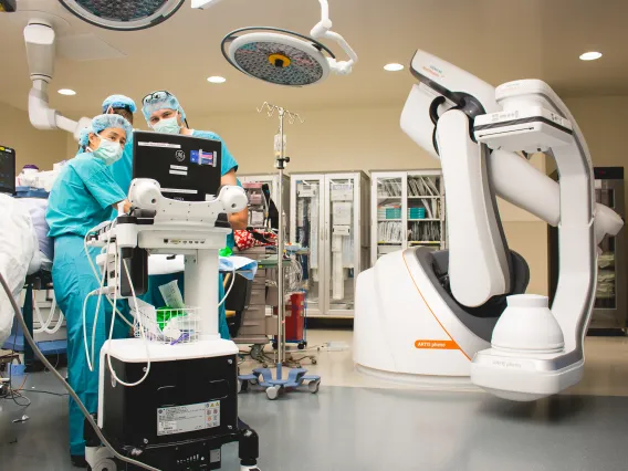 Dr. Zhou looking at a computer performing surgery