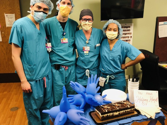 General surgeon residents group photo with cake.