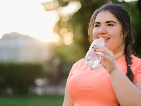 Woman outside drinking water