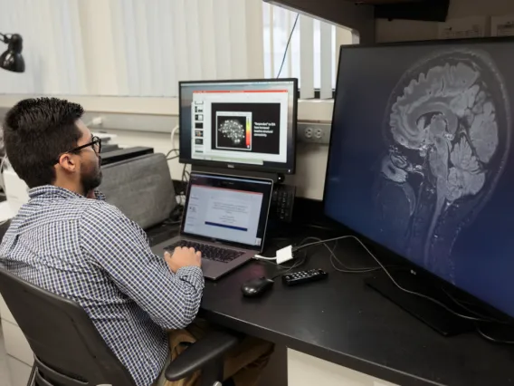 Researcher looking at brain imaging scan in the Weinkauf Lab