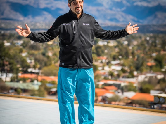 Dr. Joseph in scrubs standing on the helipad. 