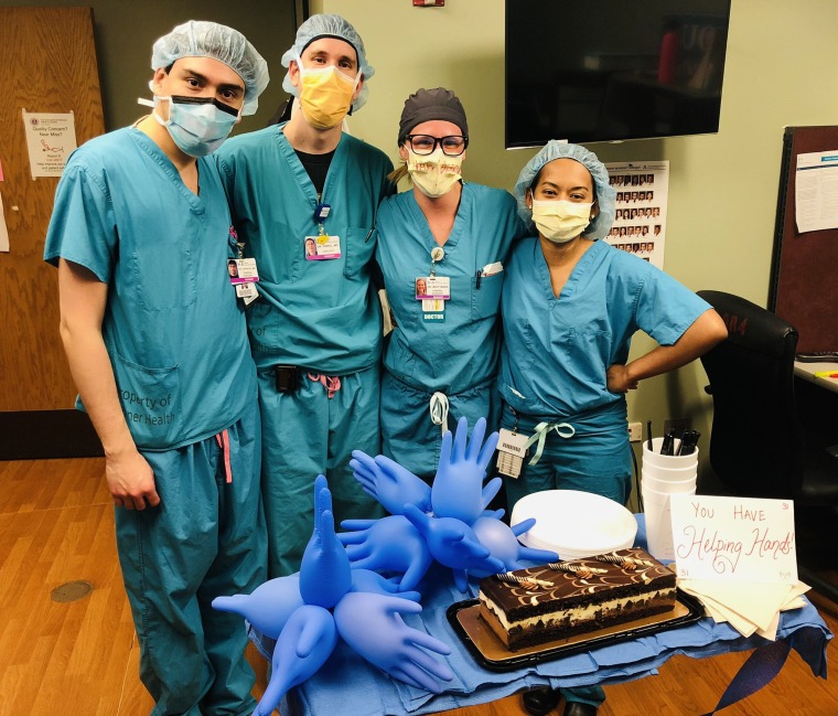 General surgeon residents group photo with cake.
